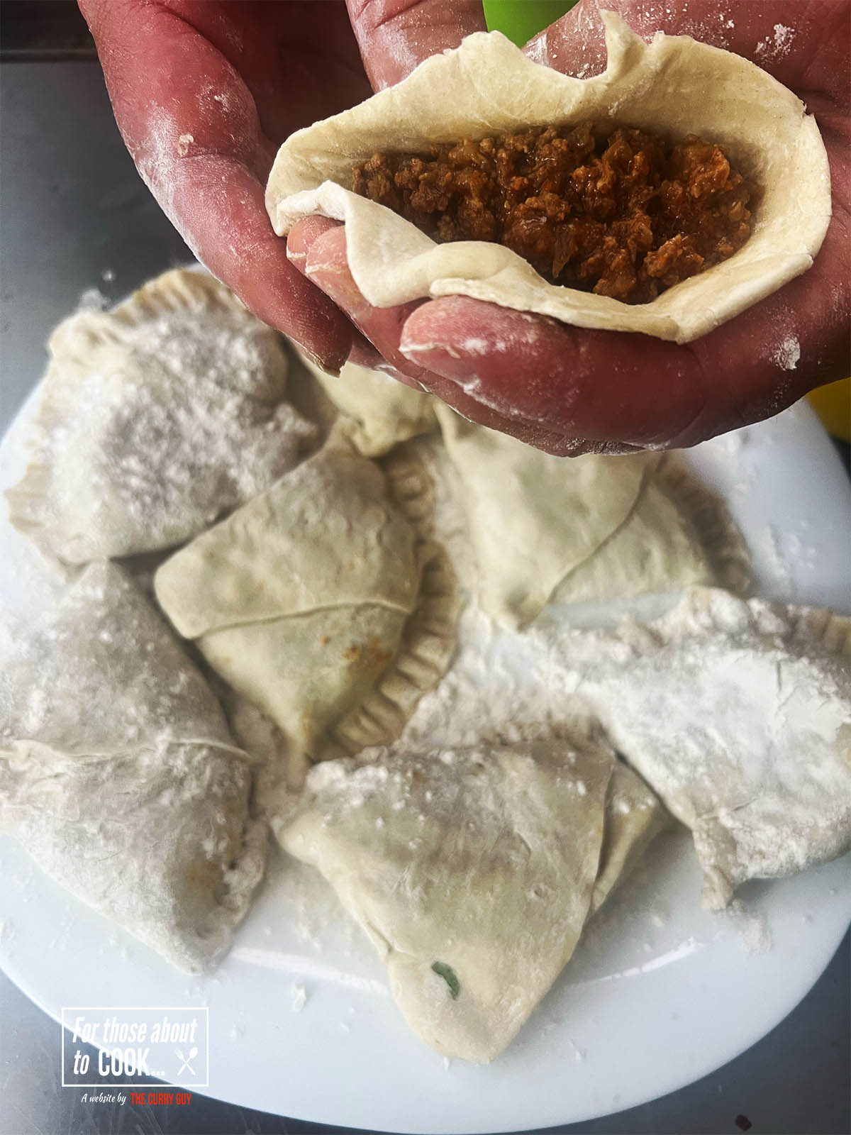 Showing a filled samosa before closing it shut.