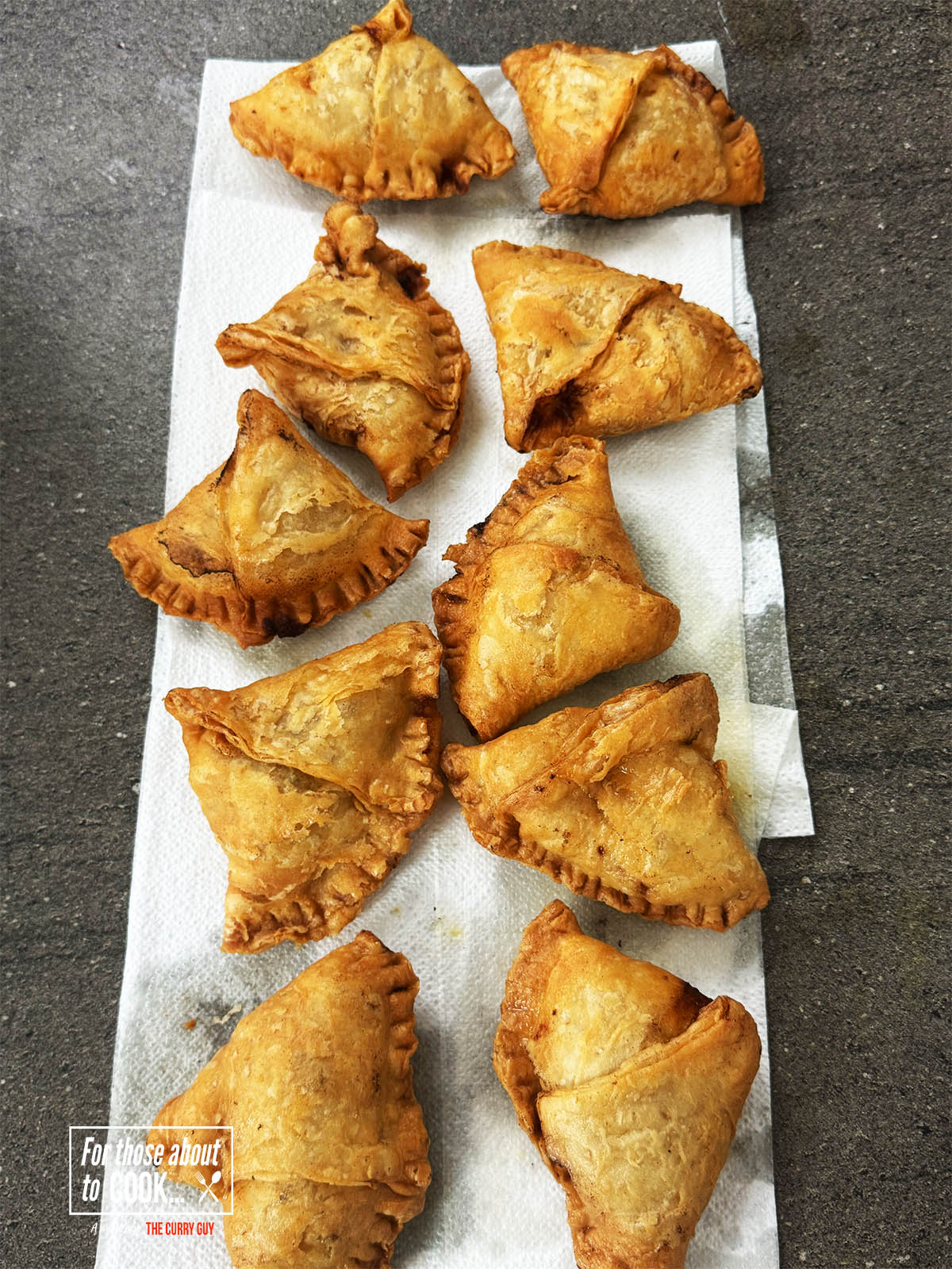 Samosas on a paper towel.