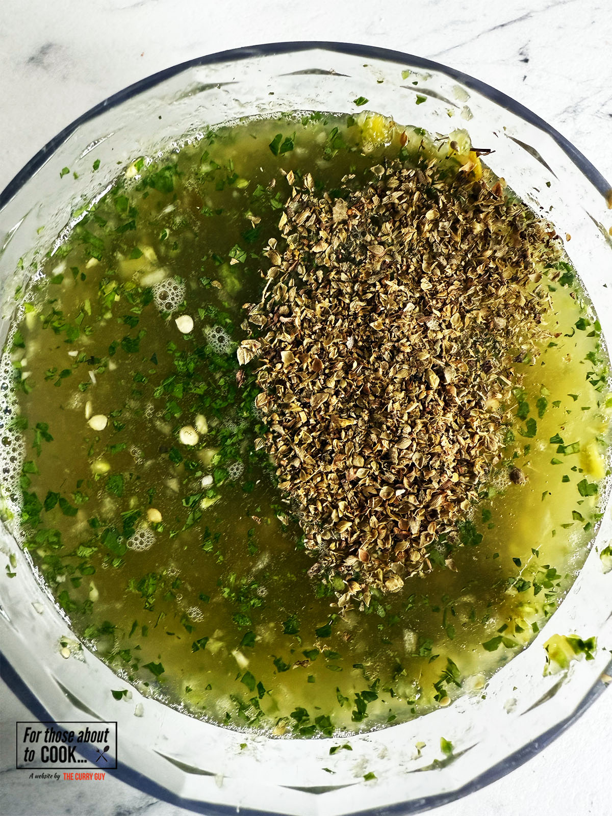Oregano added to salsa verde