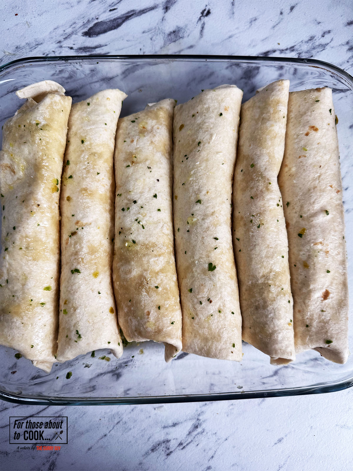 Enchiladas with verdes added to the pan rolled