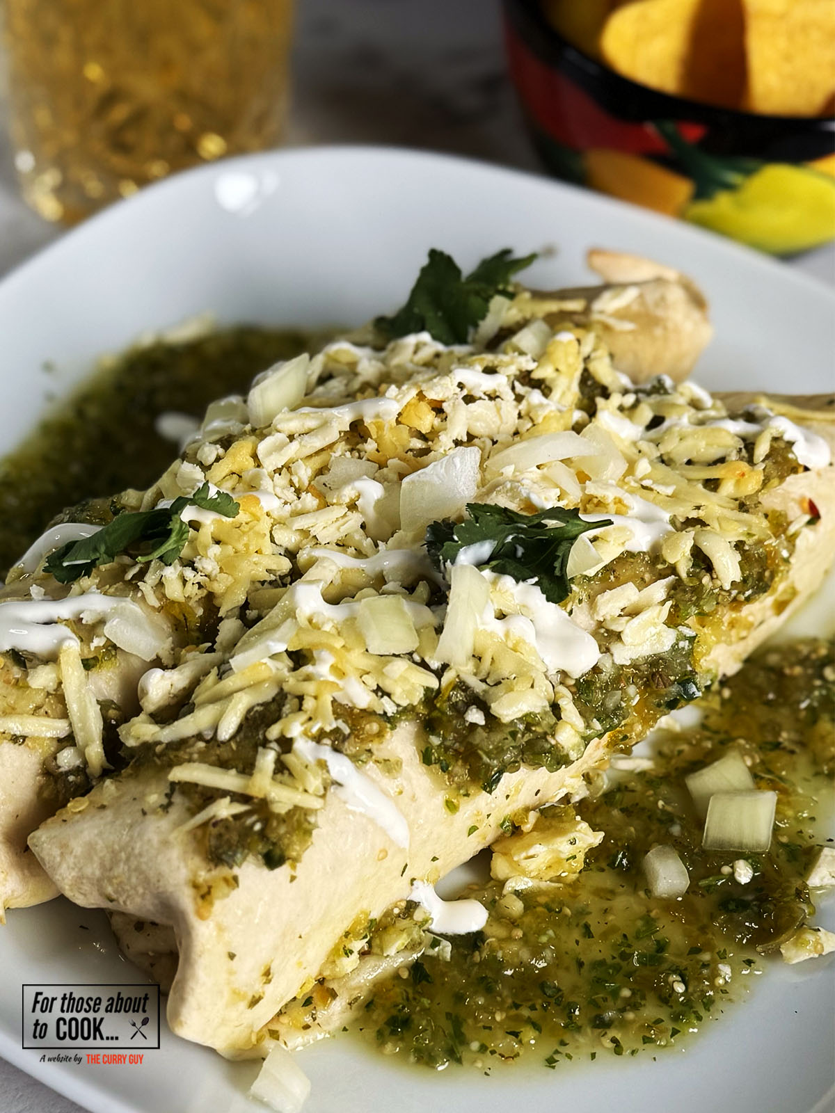 Enchiladas topped with diced onions and coriander