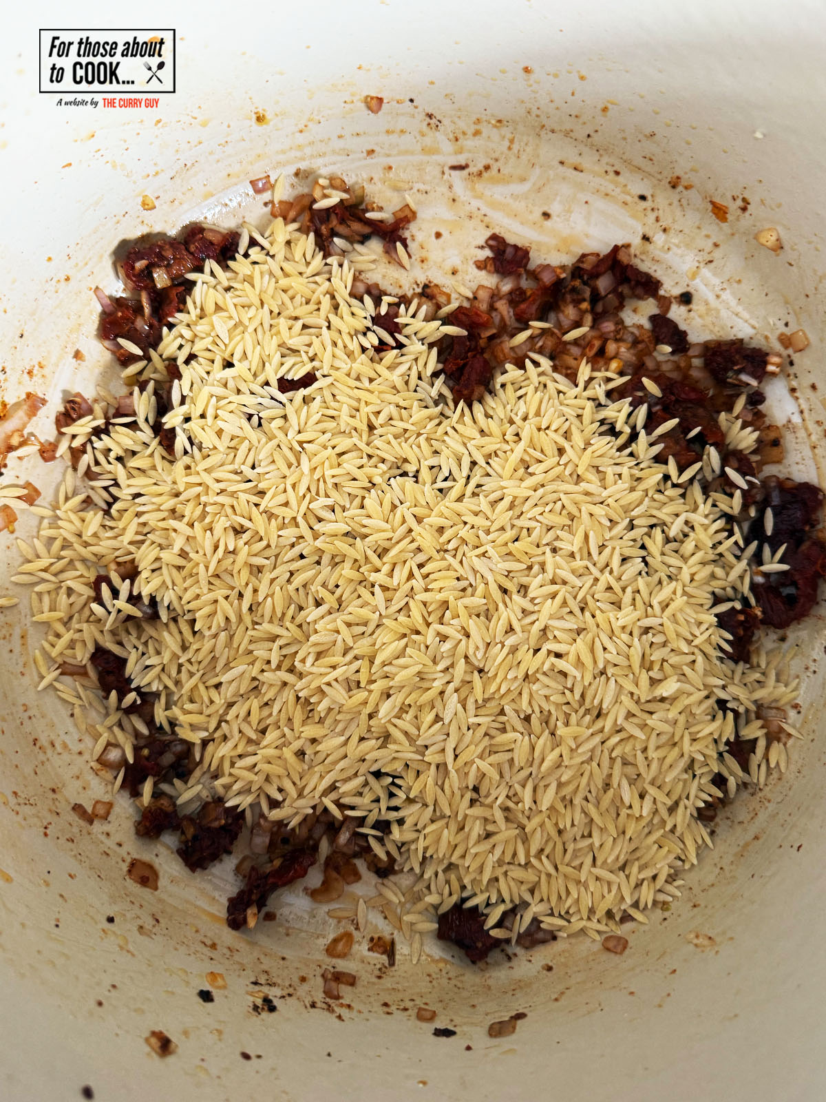 Orzo rice added to the pan