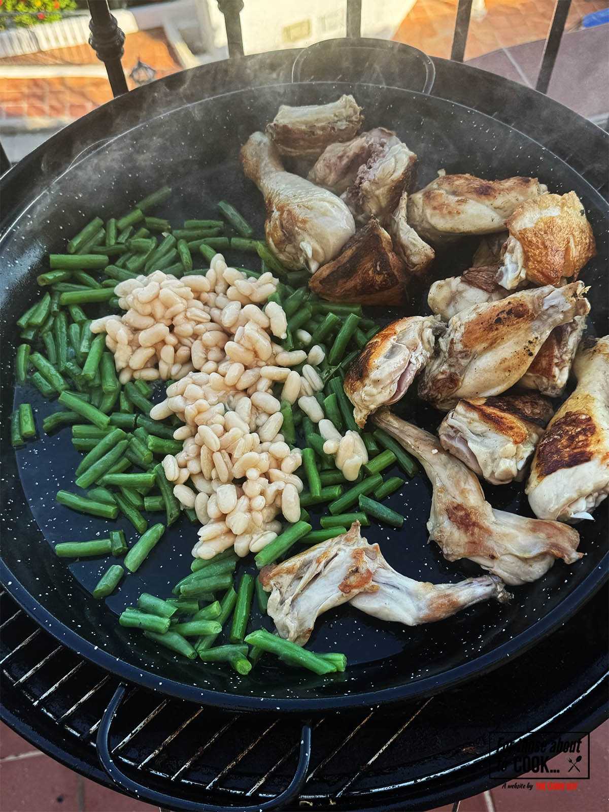 Adding the green beans and butter beans to fry for a couple of minutes in the pan.