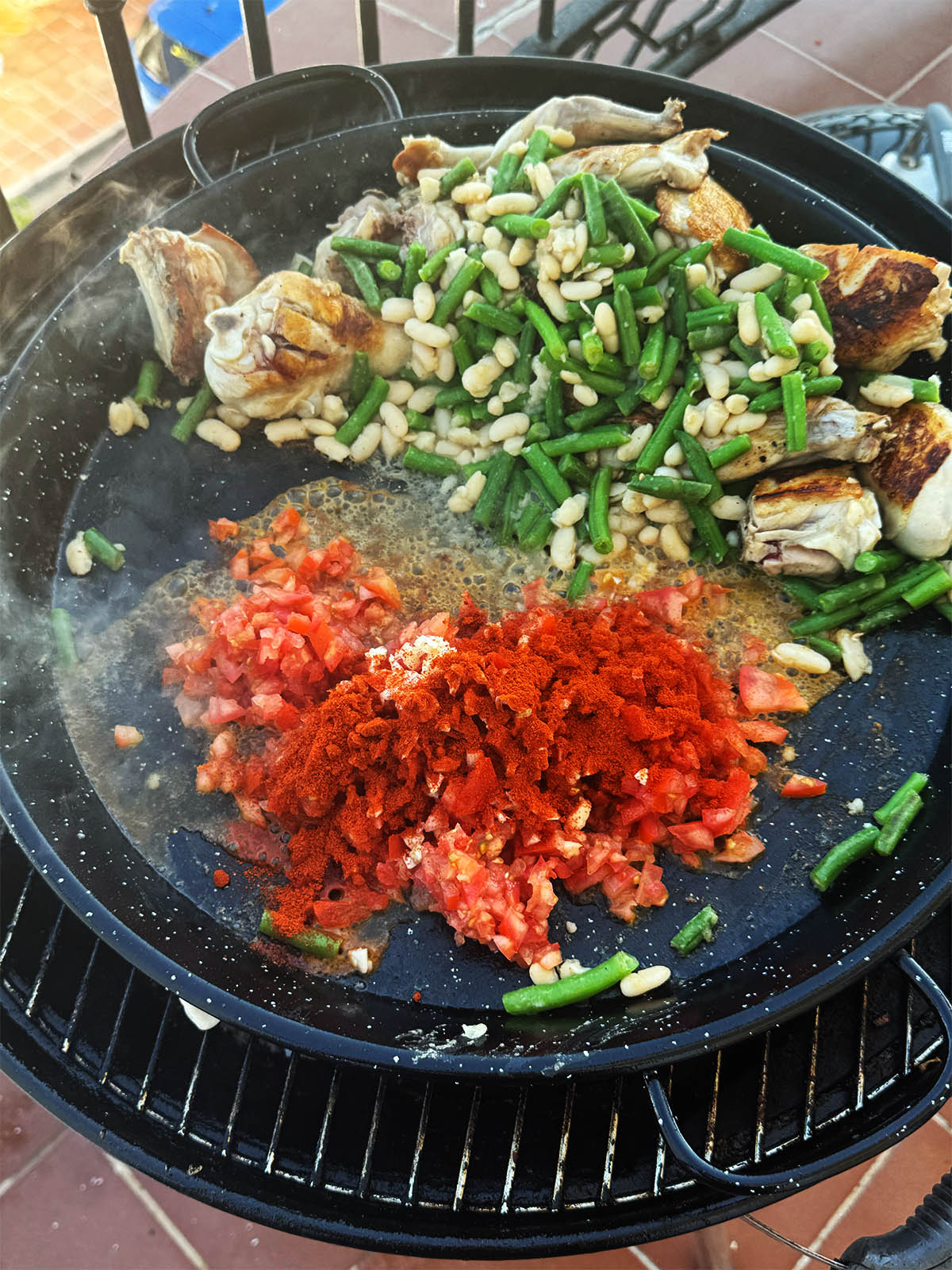 Adding the chopped tomatoes and paprika.