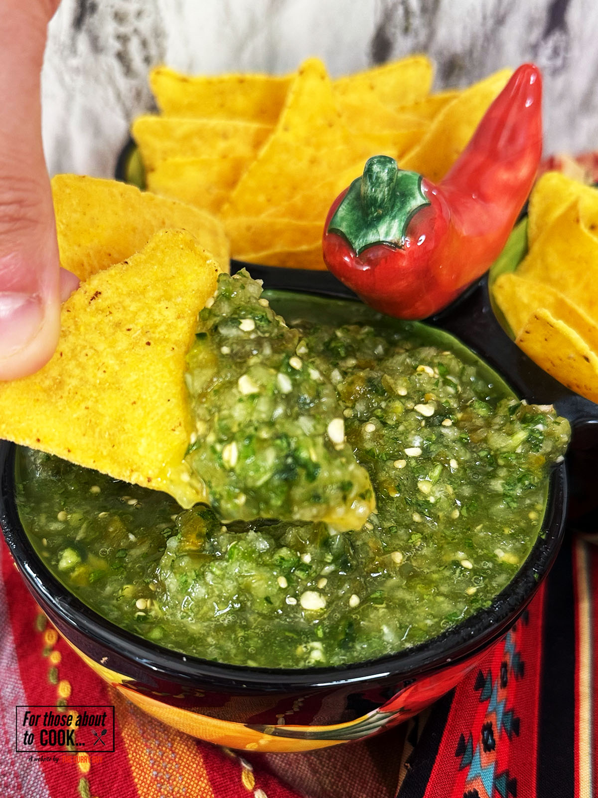 Tortilla chip dipped in Verdes