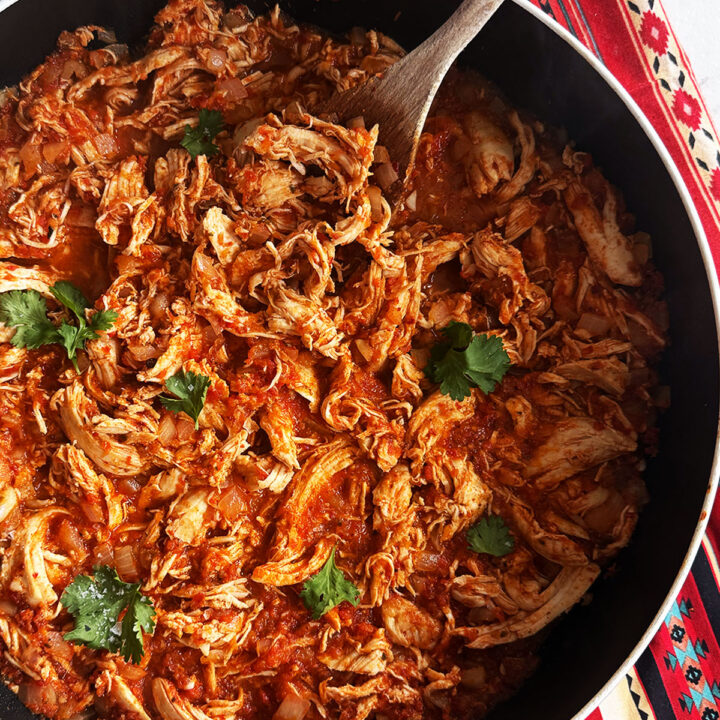 Tinga served in a pan topped with coriander