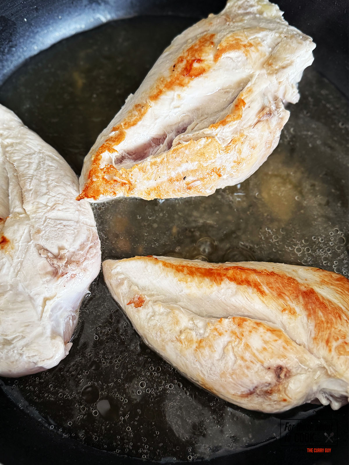 Chicken stock added to browned chicken