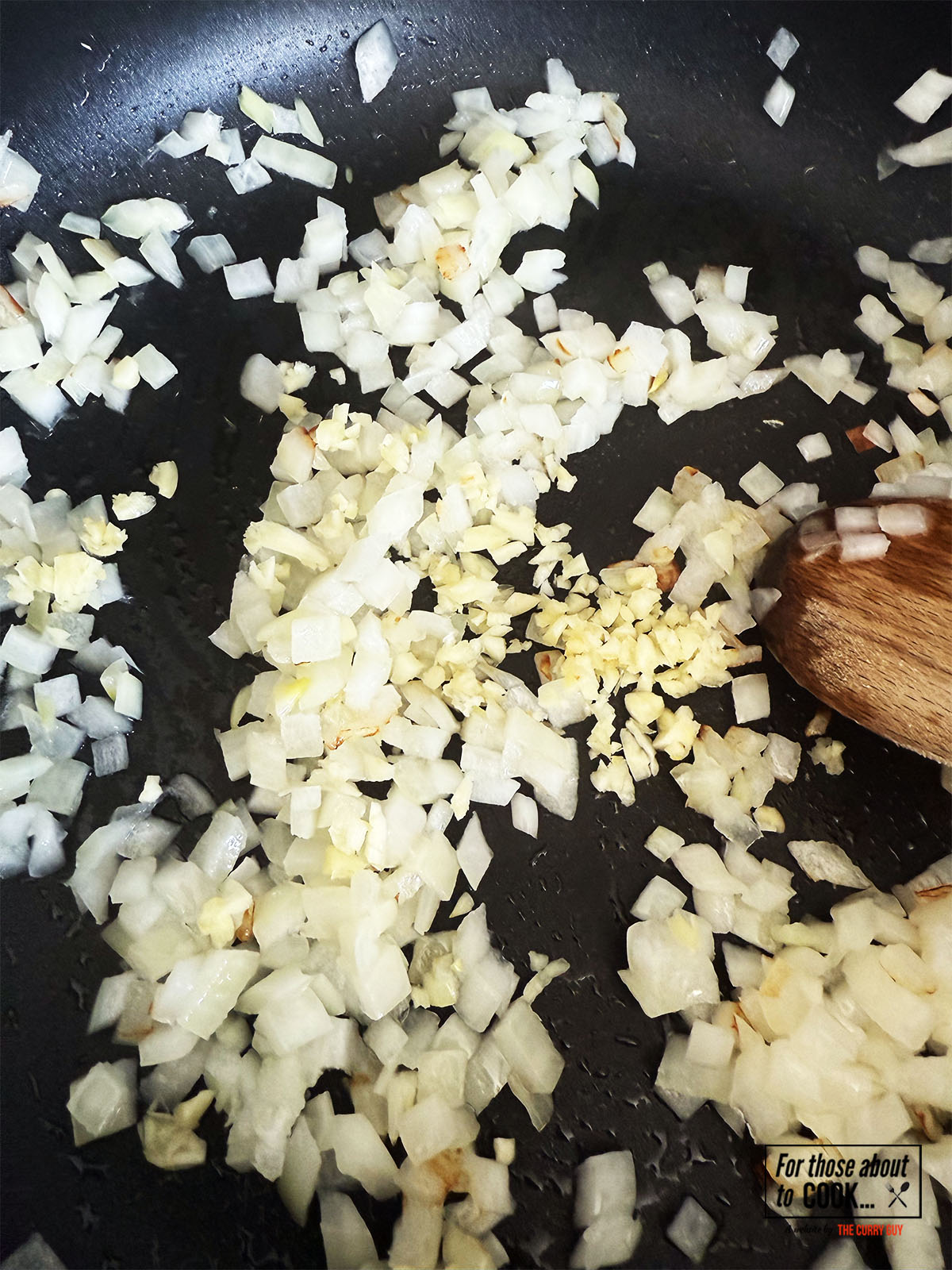 Onions and garlic sautéing in a pan