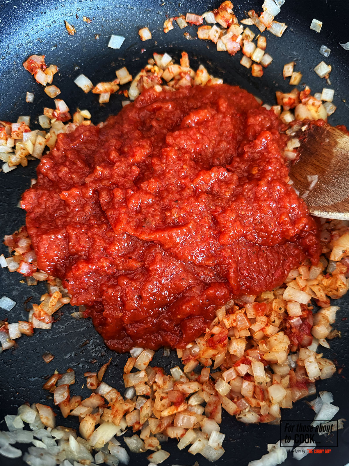 Tinga sauce added to the onions and spices