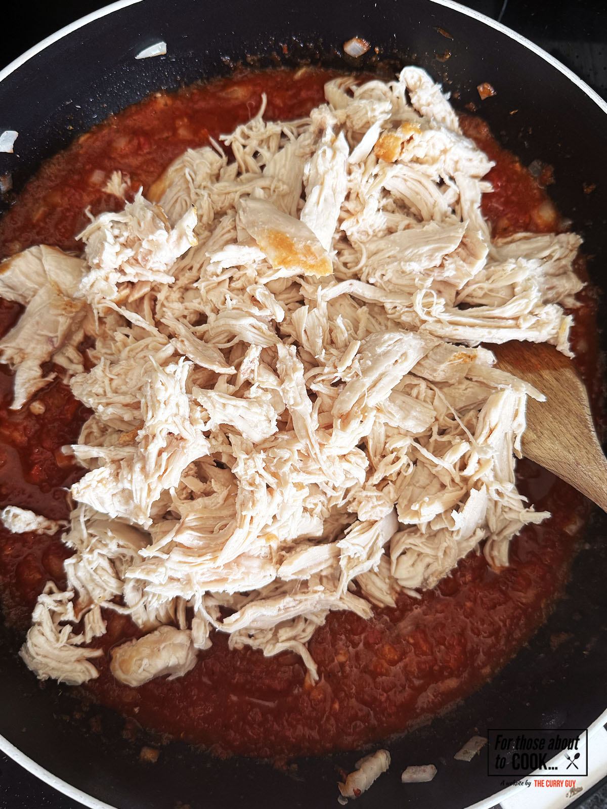 Shredded chicken added to the tinga sauce