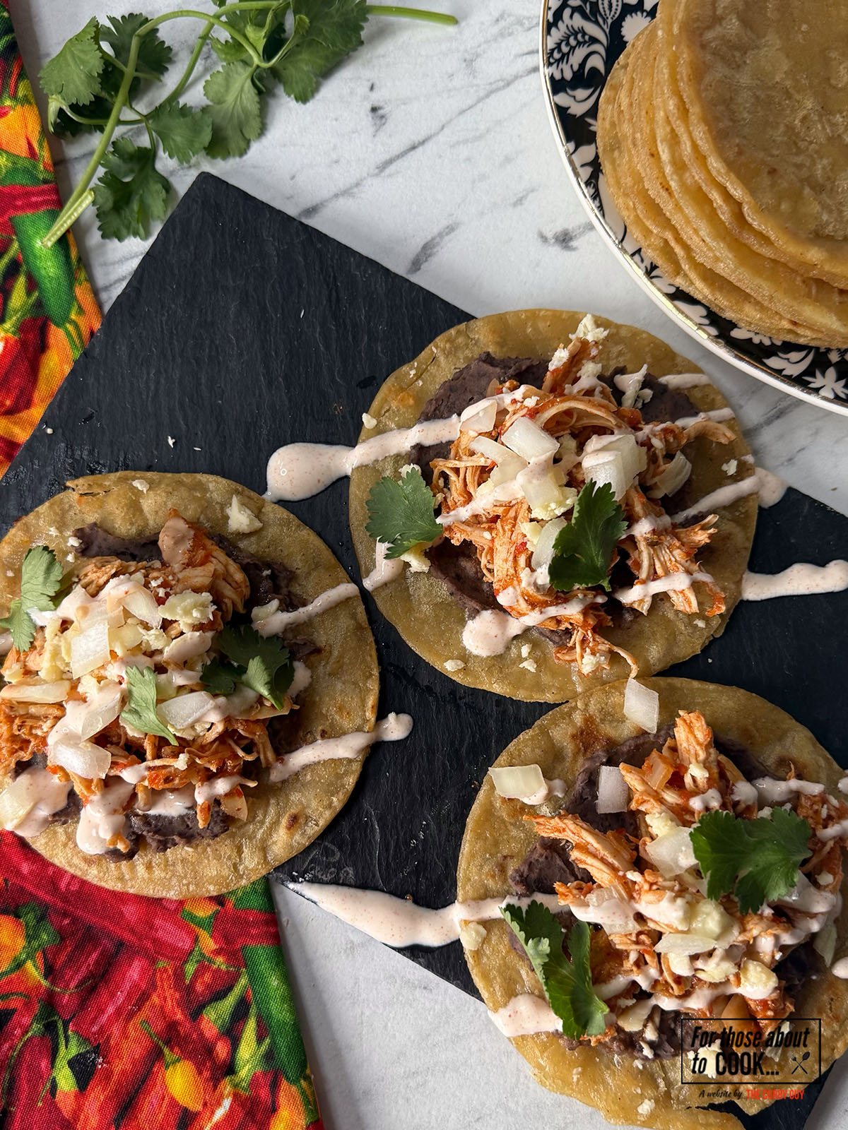Tostadas de tinga served with chipotle mayo and queso fresco cheese