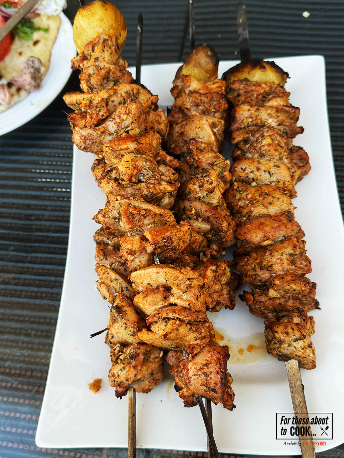 The charred chicken souvlaki resting after cooking.