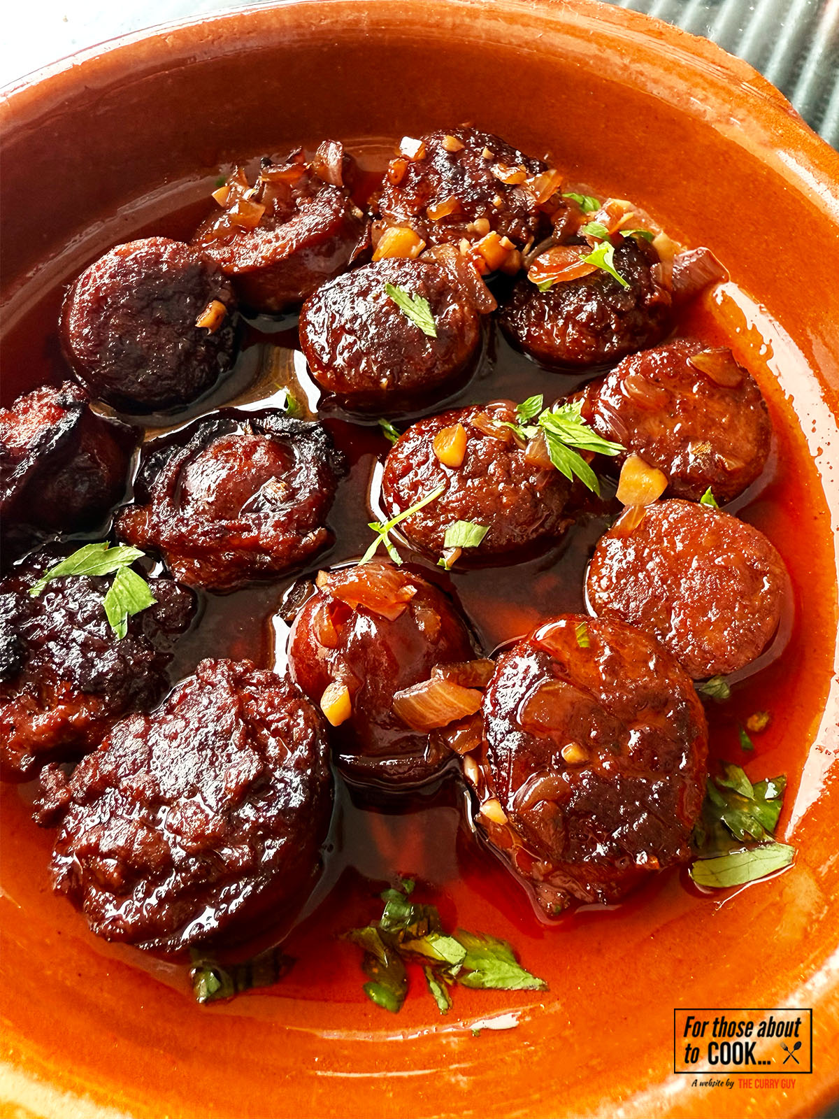Chorizo in red wine served in a tapas dish