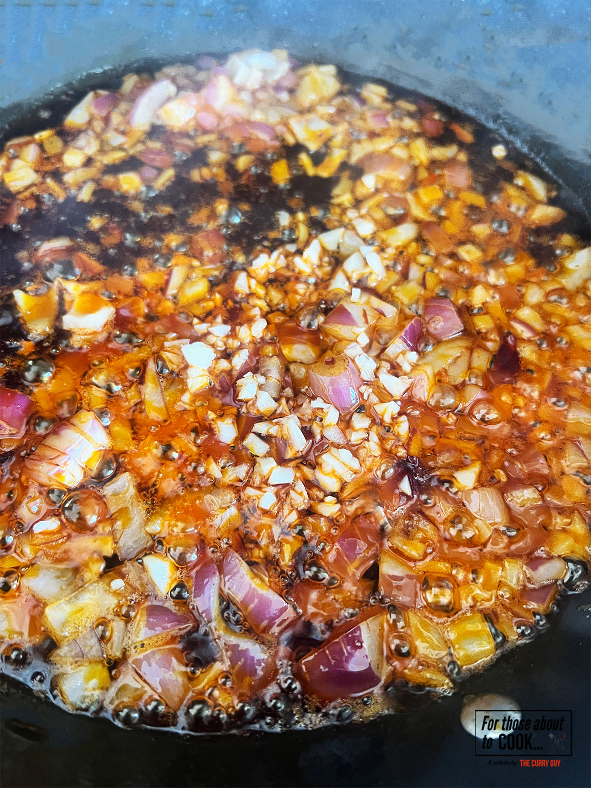 Onion and garlic frying in a pan
