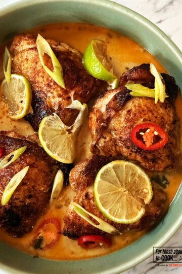 Coconut and lime crispy chicken topped with lime wedges, chilli and spring onion