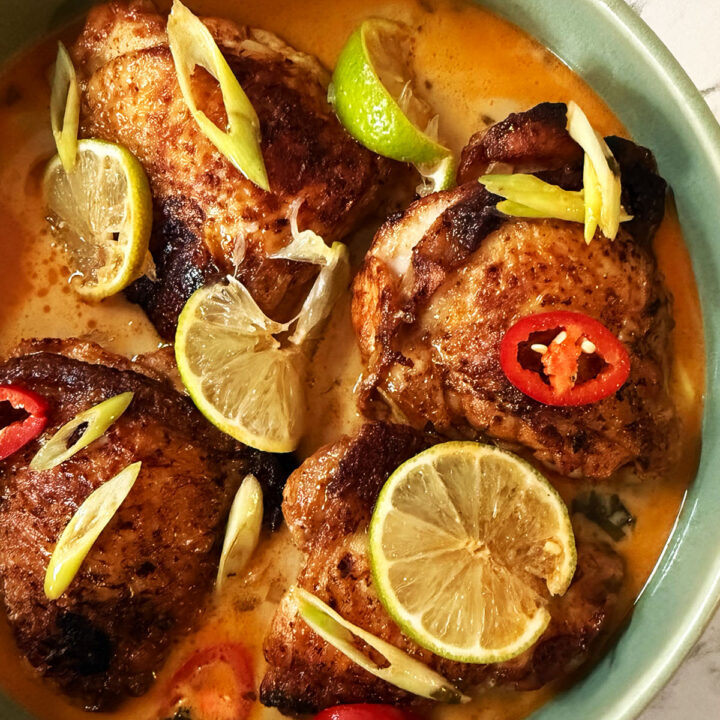 Coconut and lime crispy chicken topped with lime wedges, chilli and spring onion