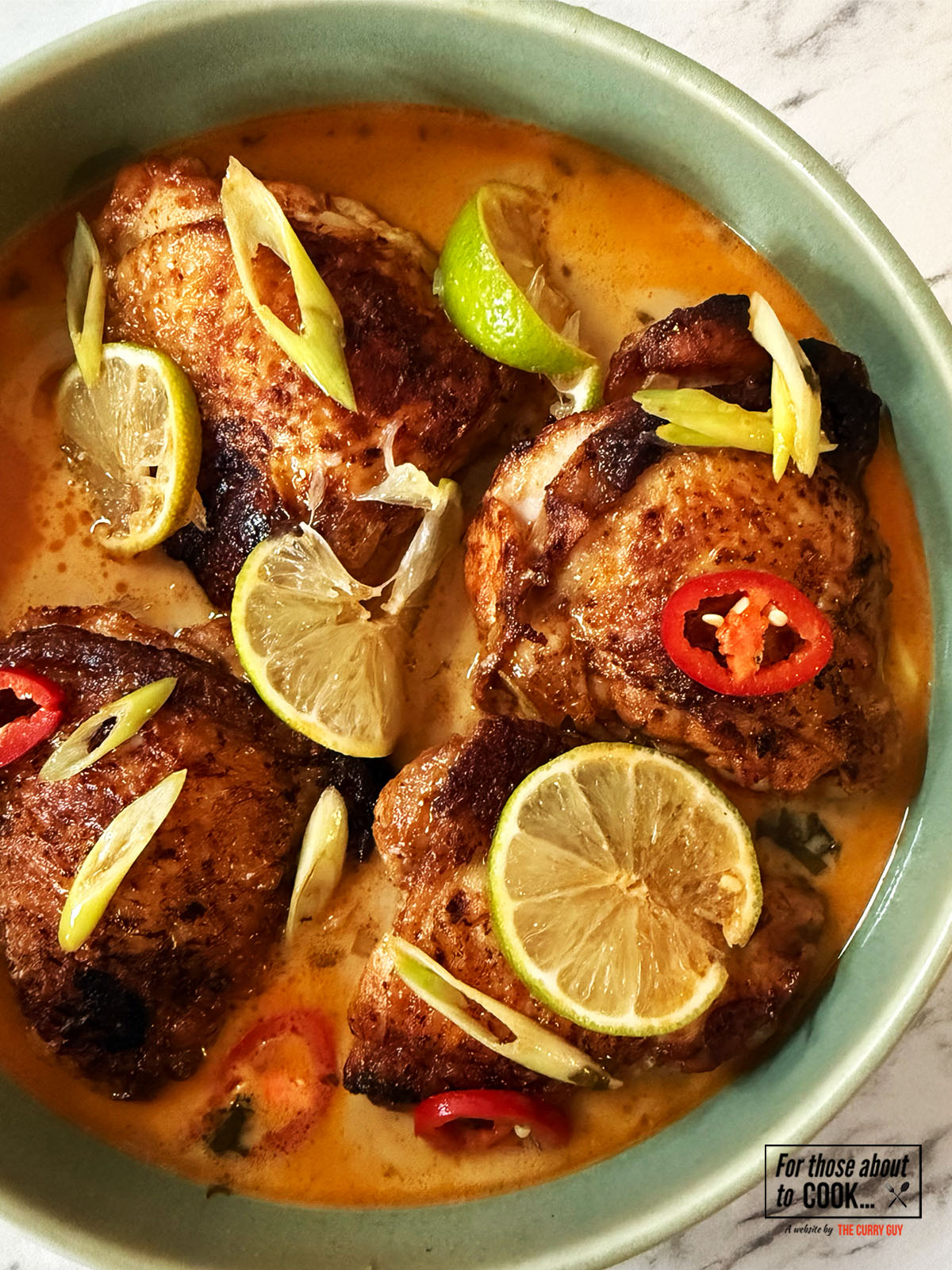 Coconut and lime crispy chicken topped with lime wedges, chilli and spring onion