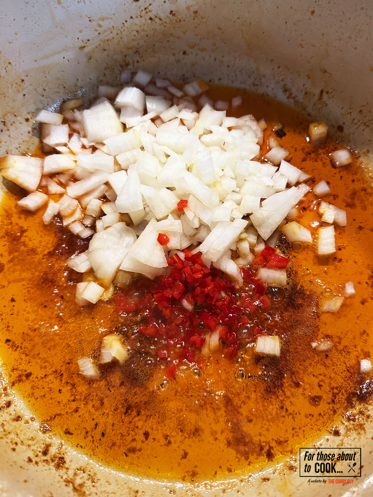 Onion and red chilli frying in a pan