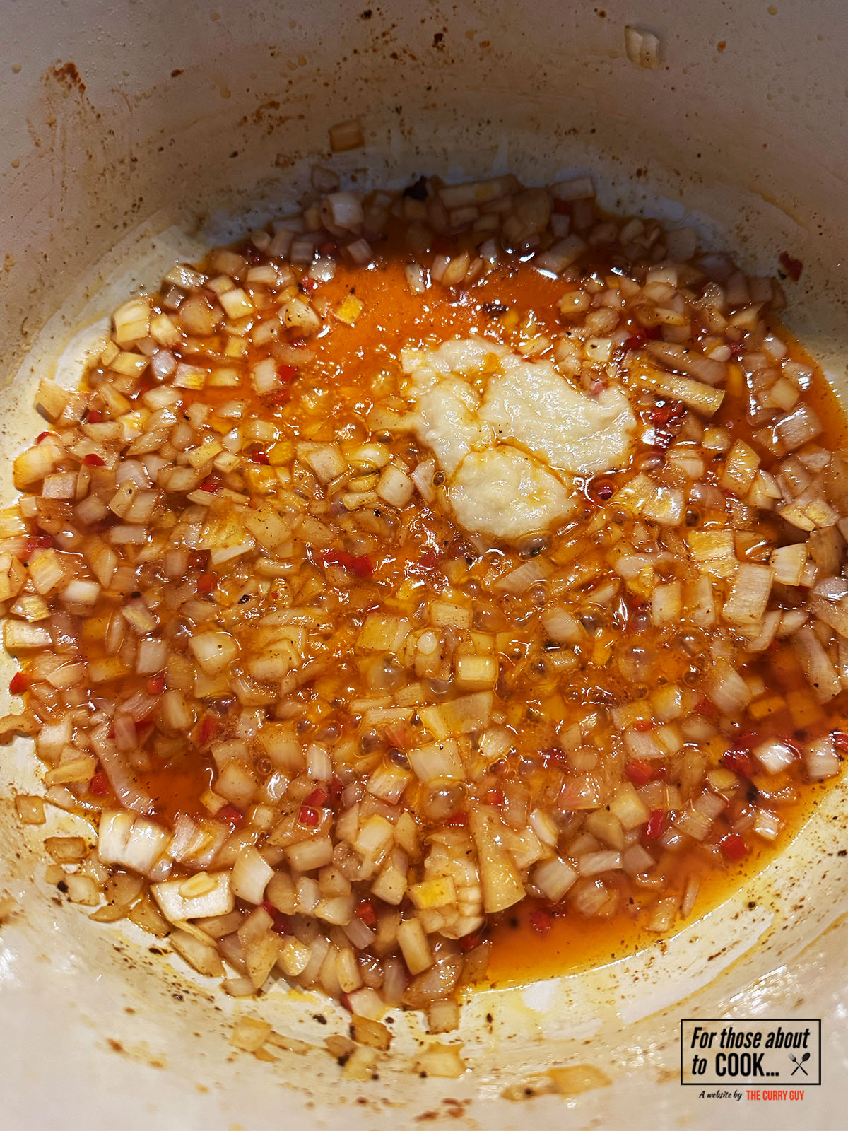 Garlic and ginger paste added to the pan