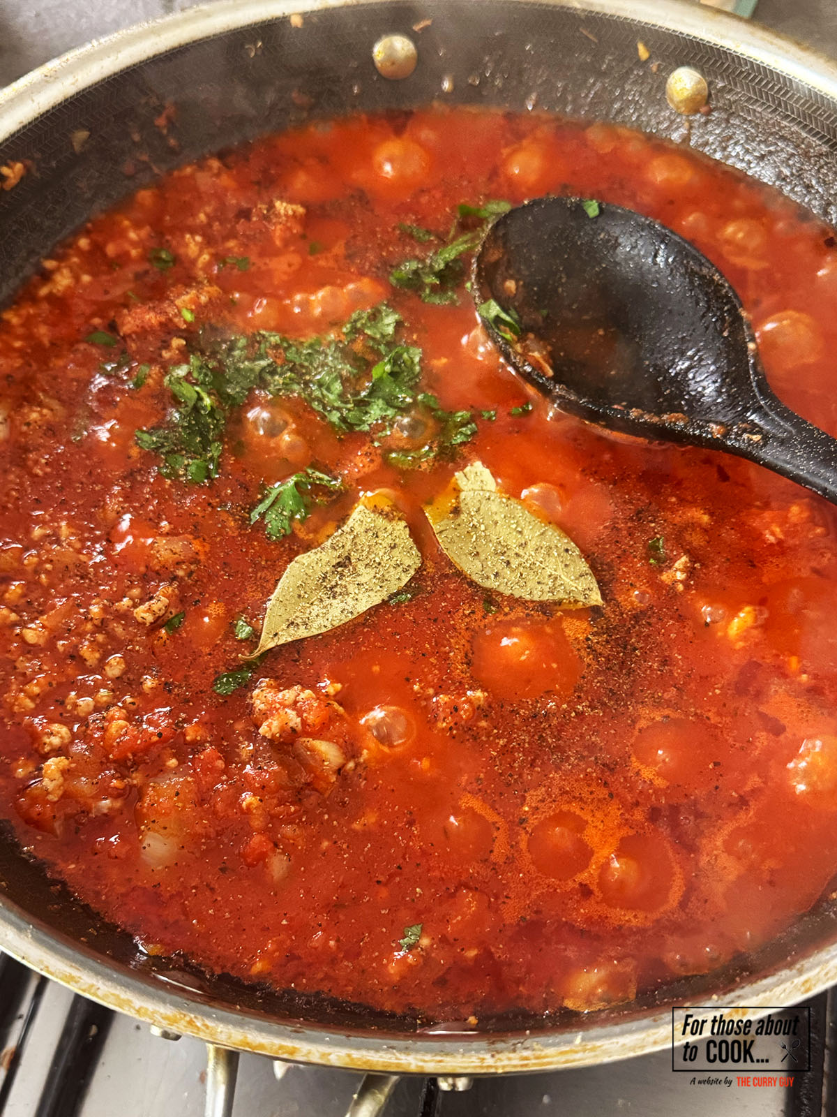 adding tomato and topping with fresh herbs