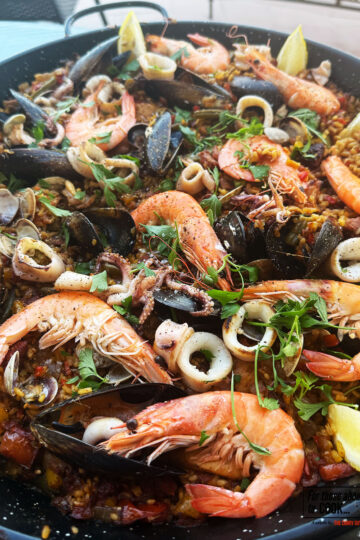 Paella mixta presented in a paella pan