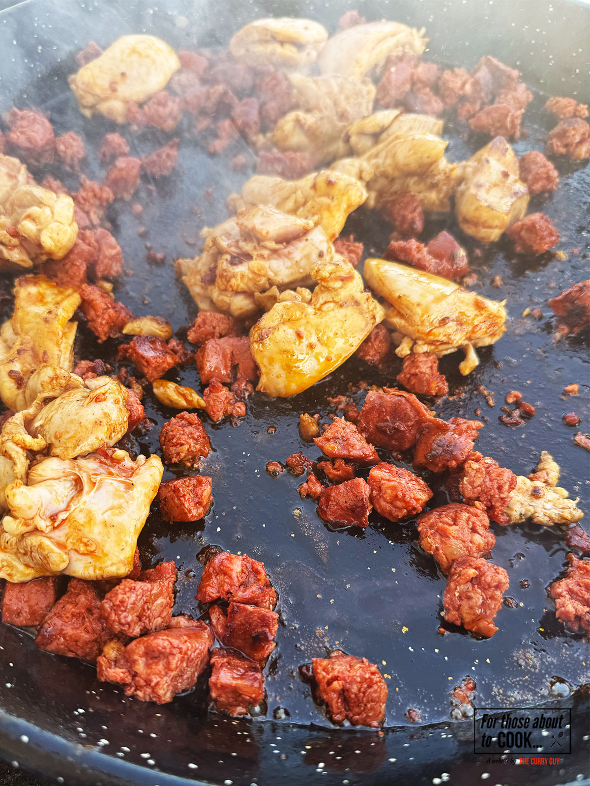 Chicken and chorizo added to the pan until browned