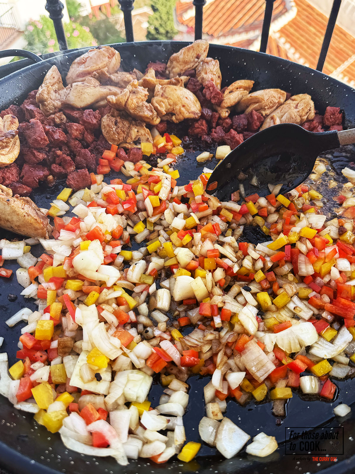 Onion and bell peppers added to the pan