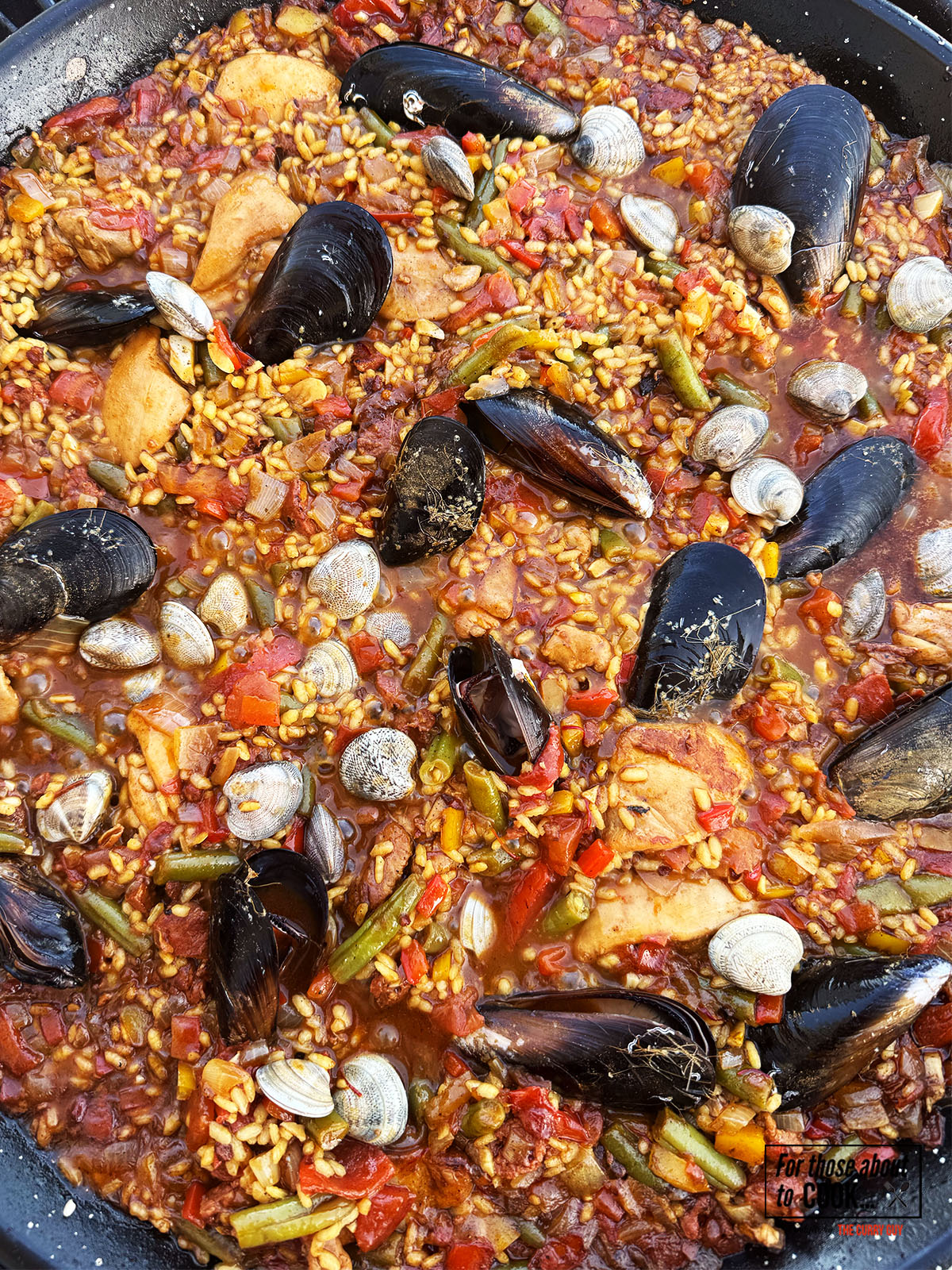 Mussels and clams added to the pan