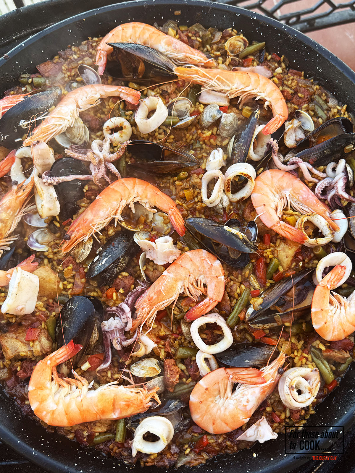 Prawns, mussels and squid added to the pan