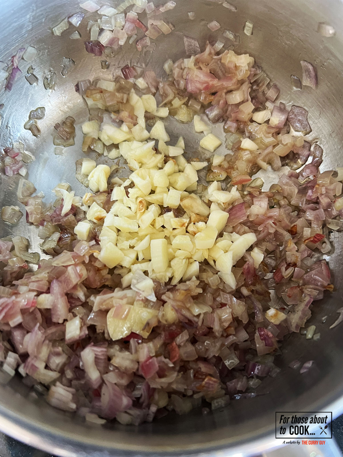 Onion and garlic sautéing in a pan