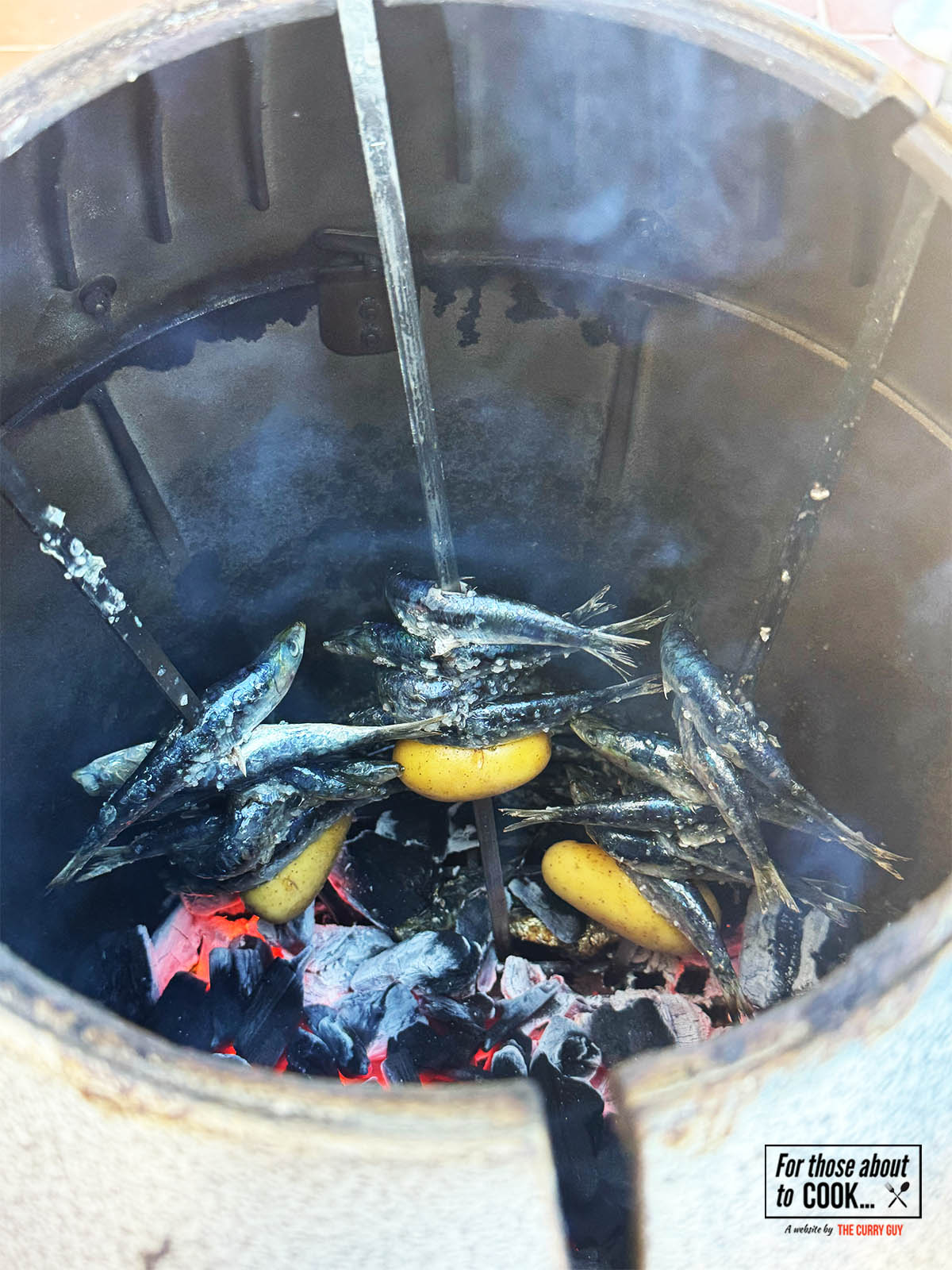 Cooking the grilled sardines in a tandoori oven.