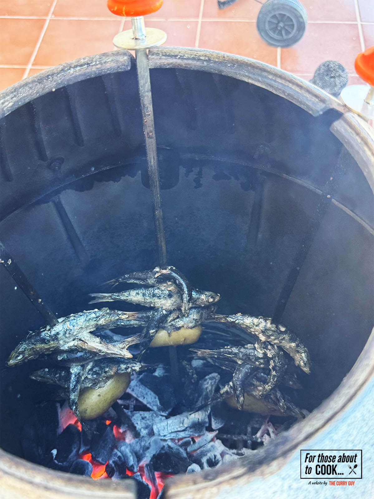 The charred sardines ready to remove from the heat.