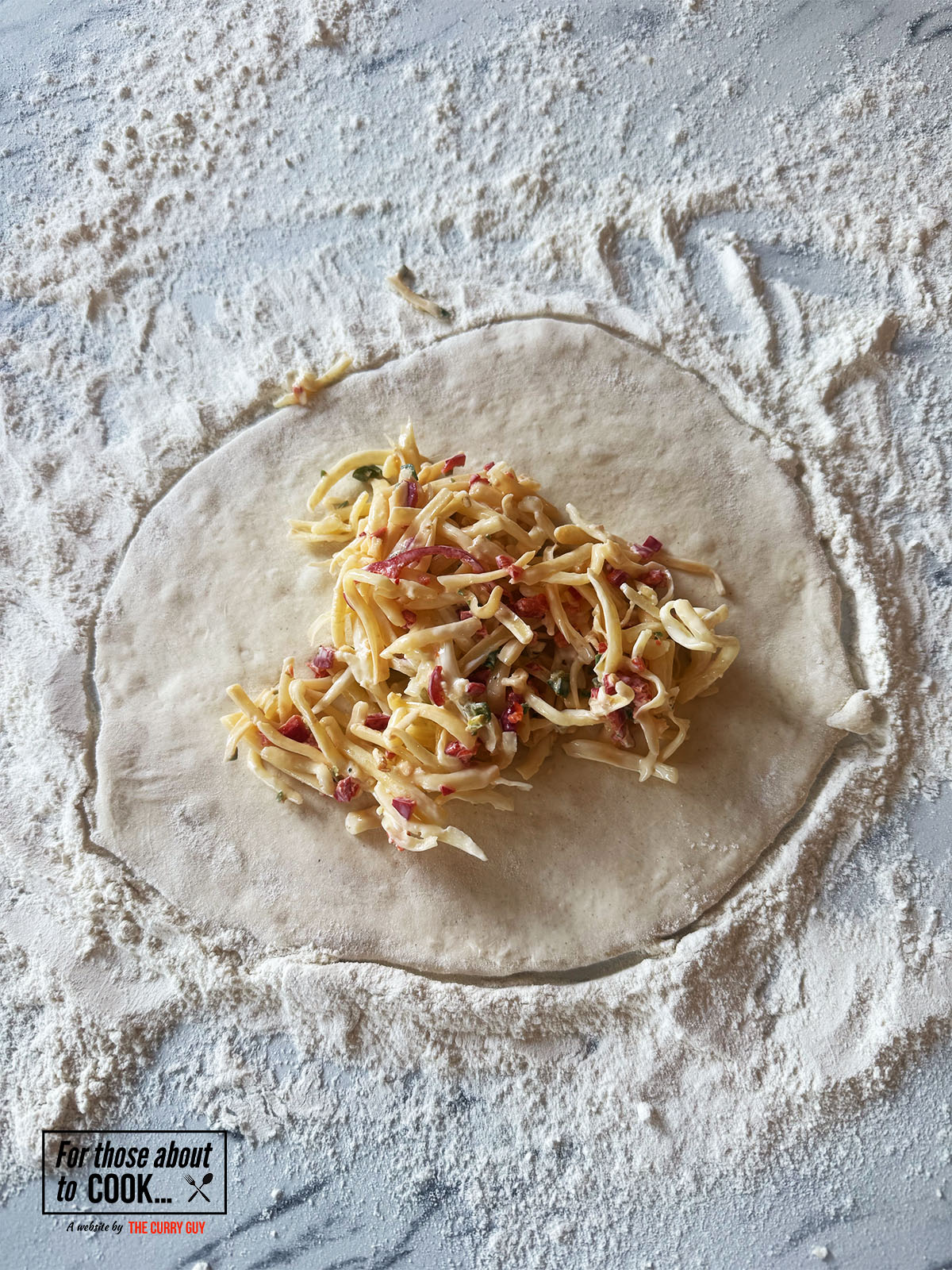 Dough rolled out and chili cheese mixture placed in the middle