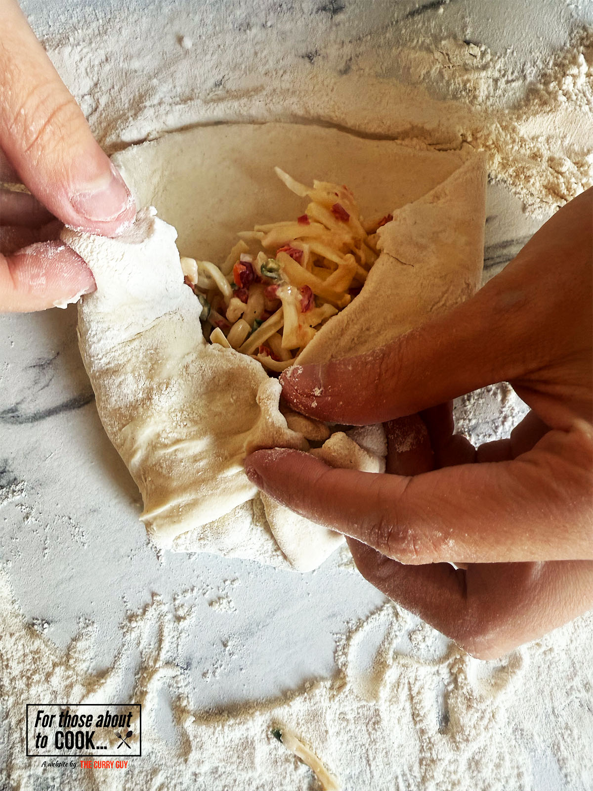 pinching the dough to seal the filling