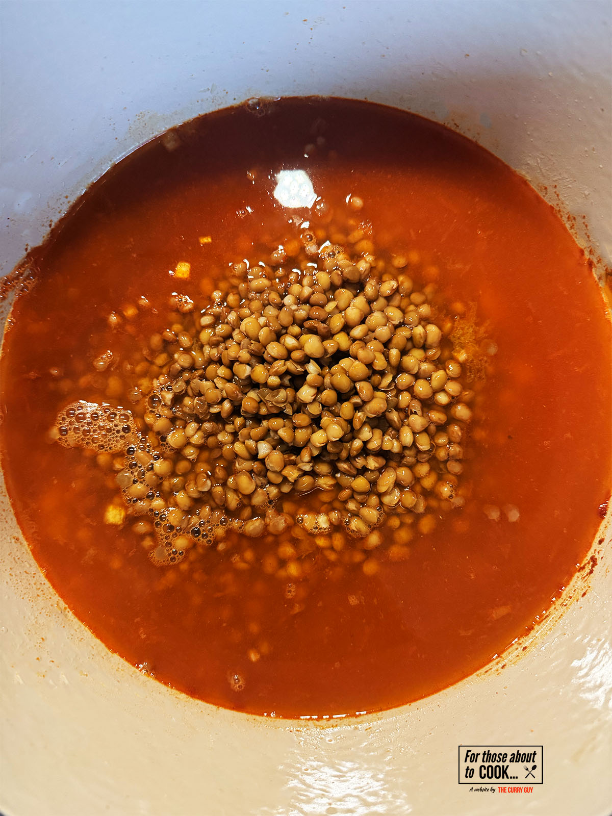 Stock and lentils added to the pot