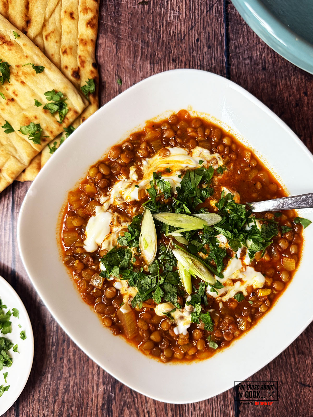 Persian lentil soup topped with yoghurt, parsley and spring onion