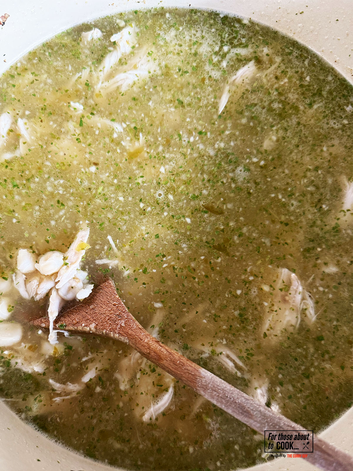 returning the stock to the pozole verde pan with the hominy