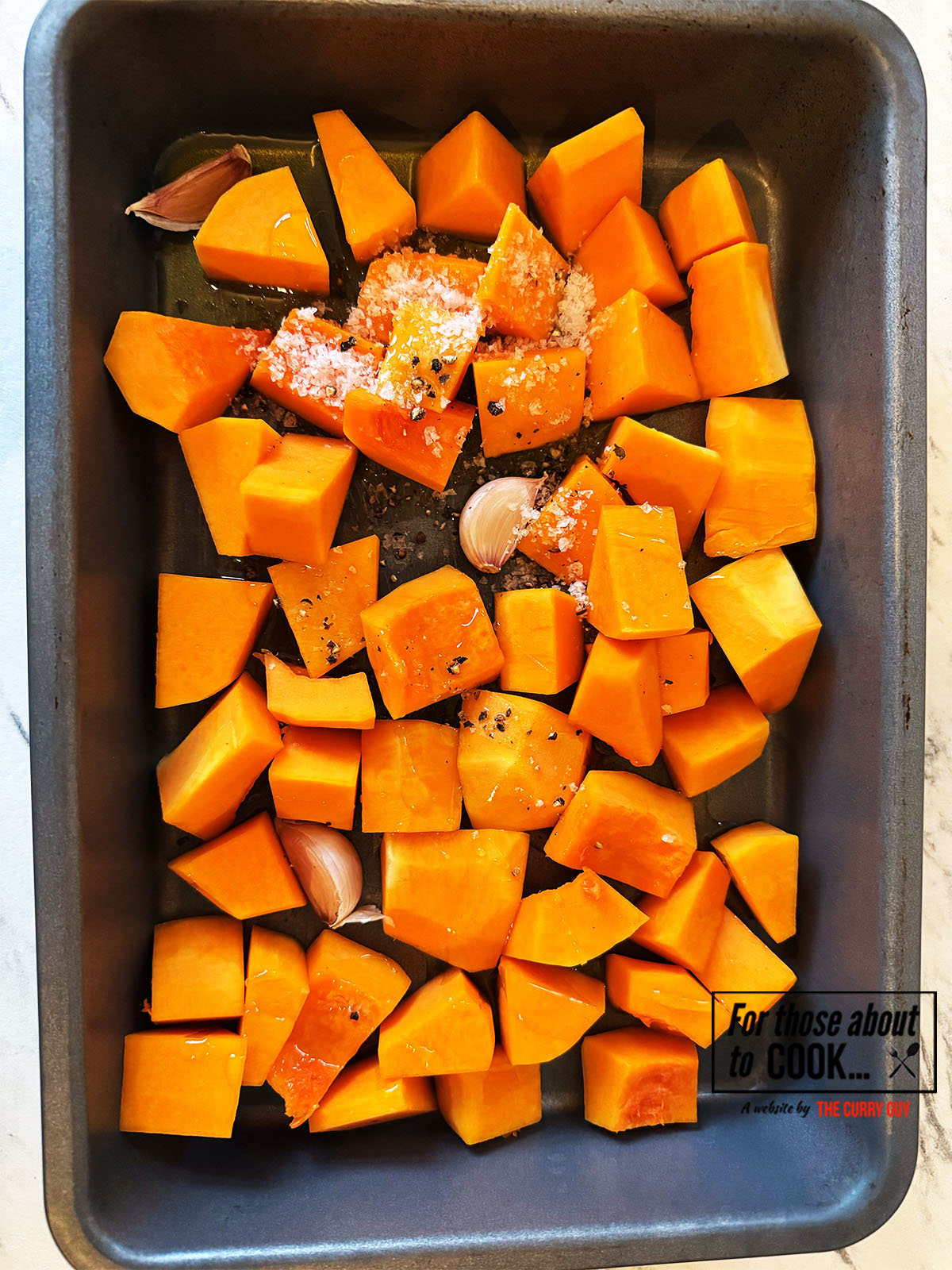Butternut squash covered in oil and salt and pepper ready to roast