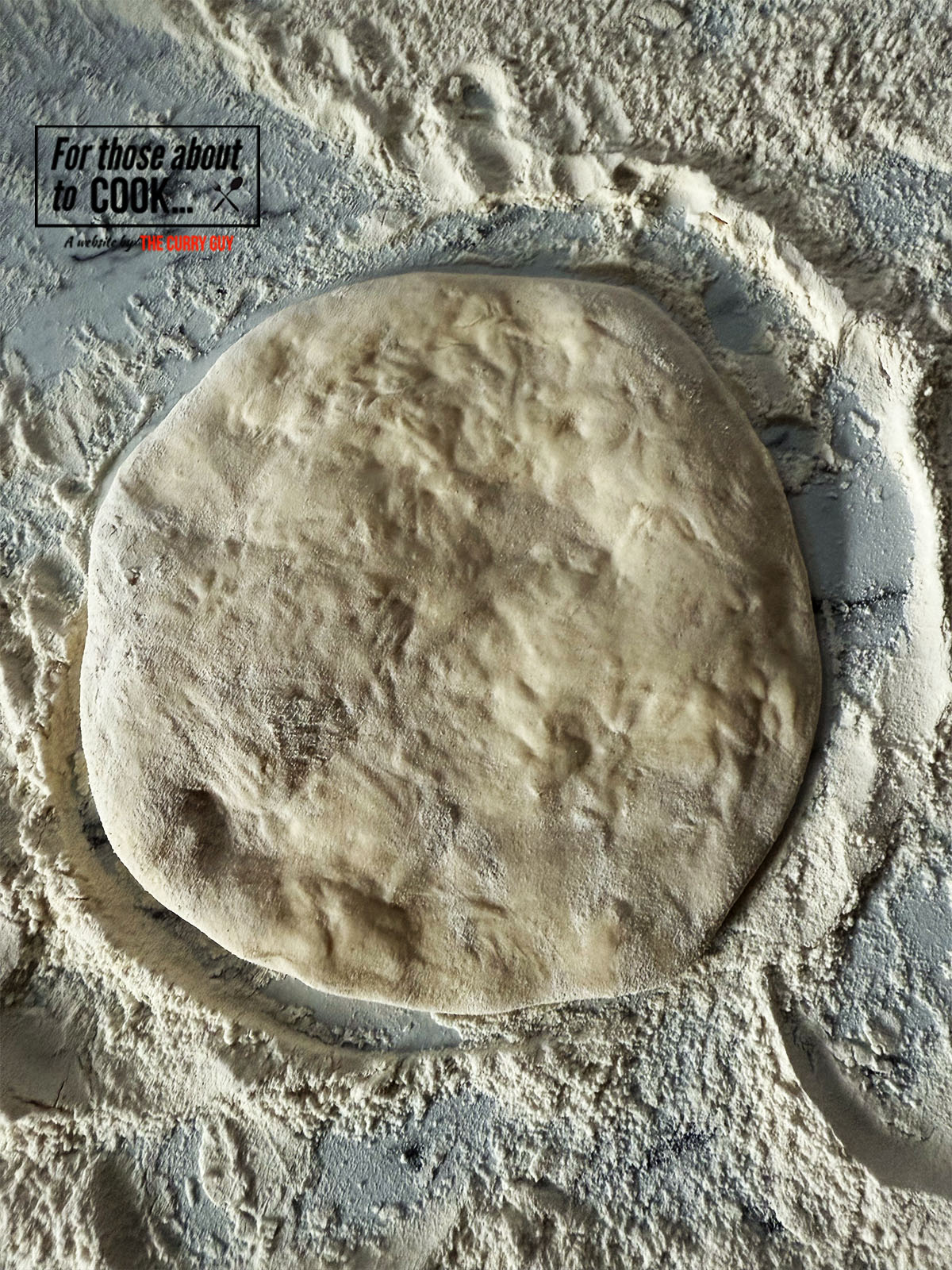 Flattening the cheese naan