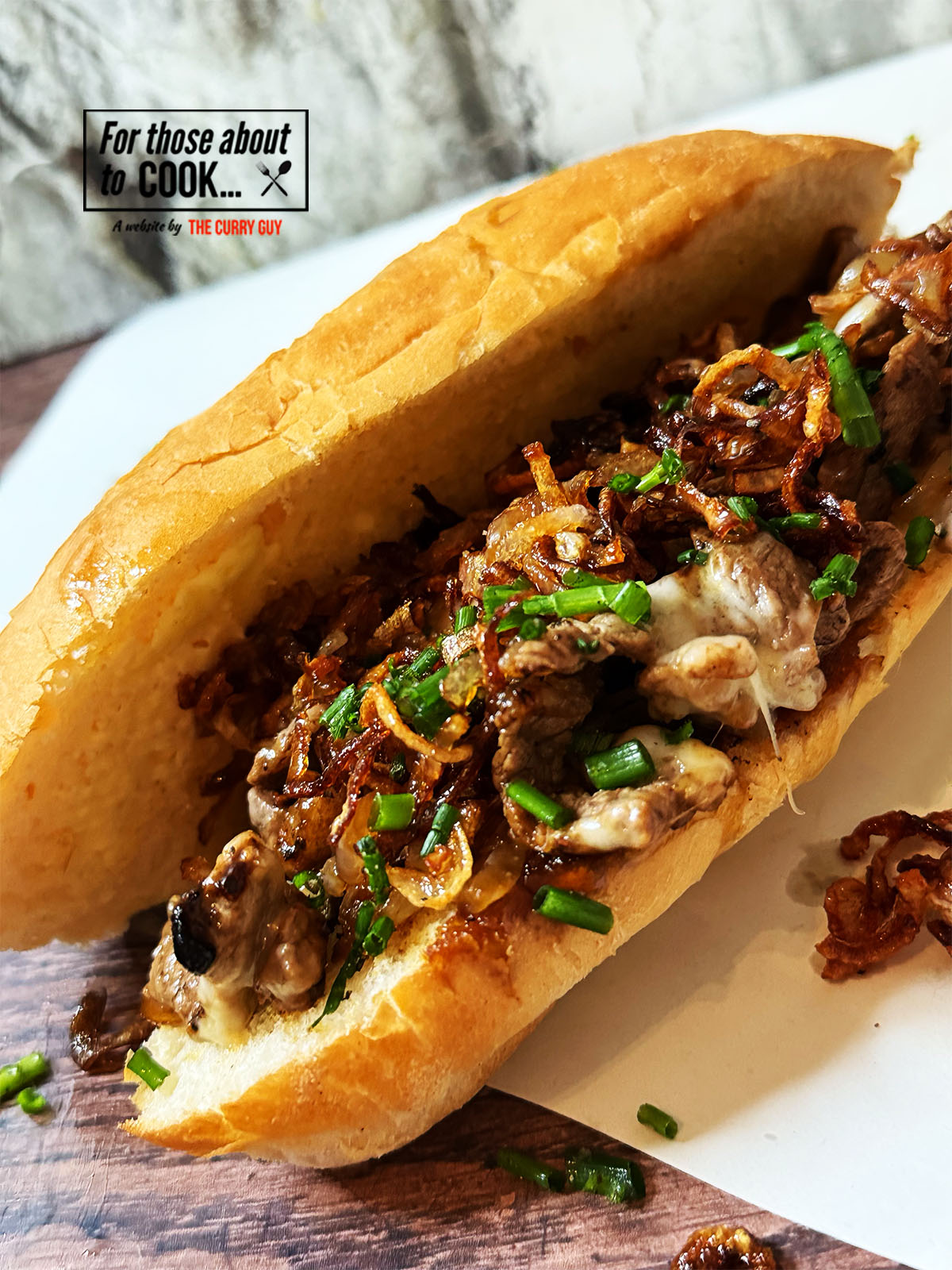 loading up the philly cheesesteak