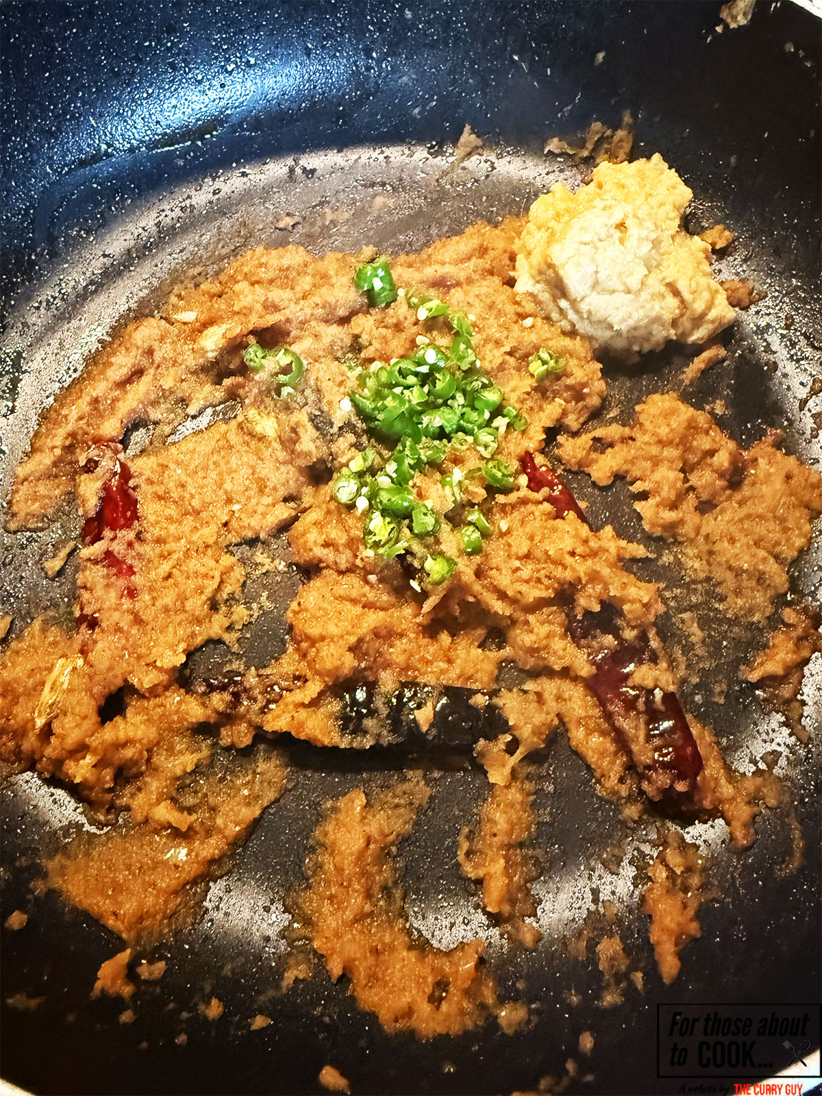 Blended onions, garlic and ginger paste and whole chillies frying