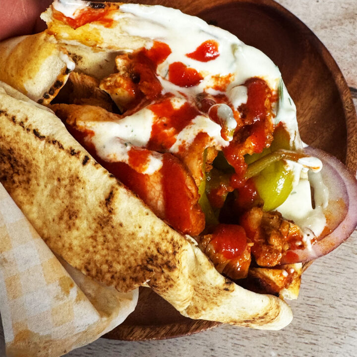 Chicken shawarma in a wrap with sauce