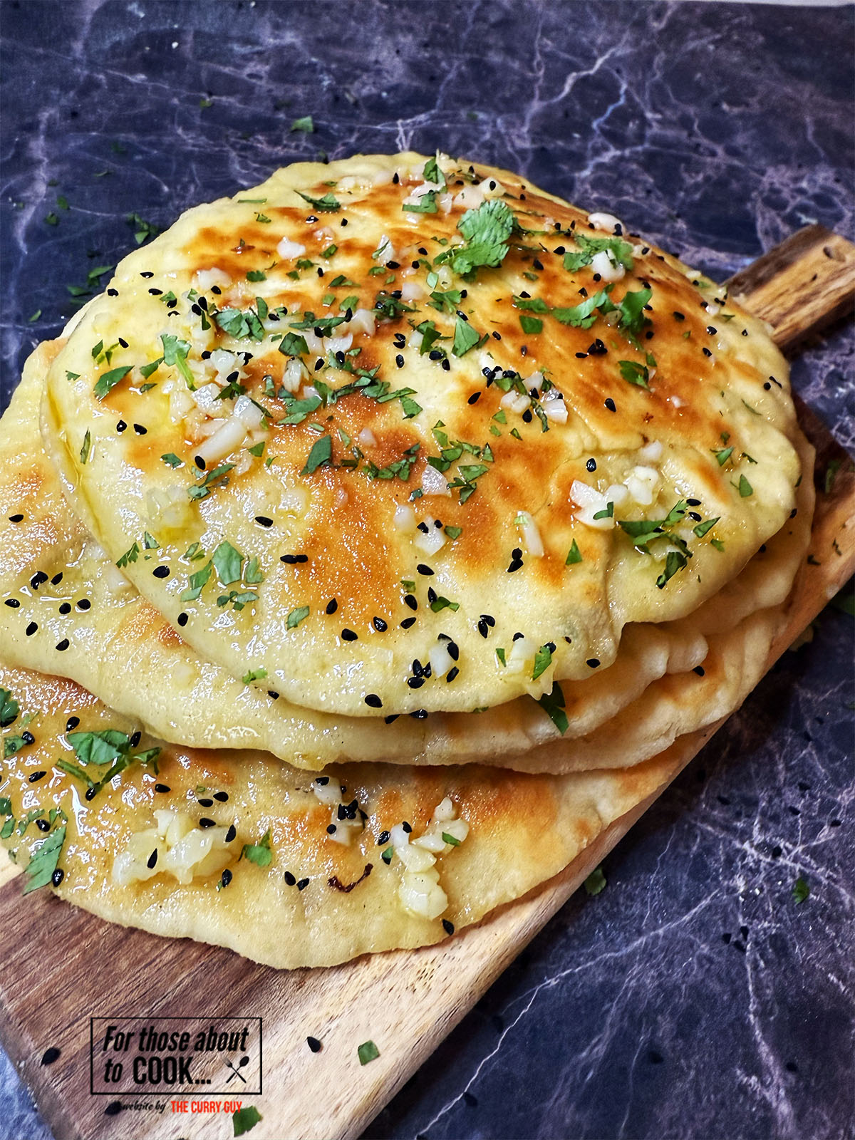 Naans sprinkled with nigella seeds, coriander and garlic ghee