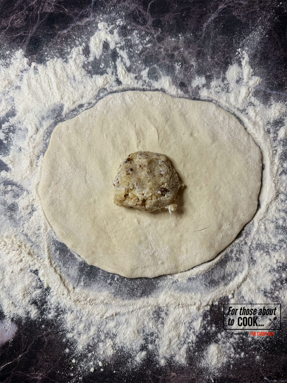 Naan dough rolled out and peshwari filling in the centre