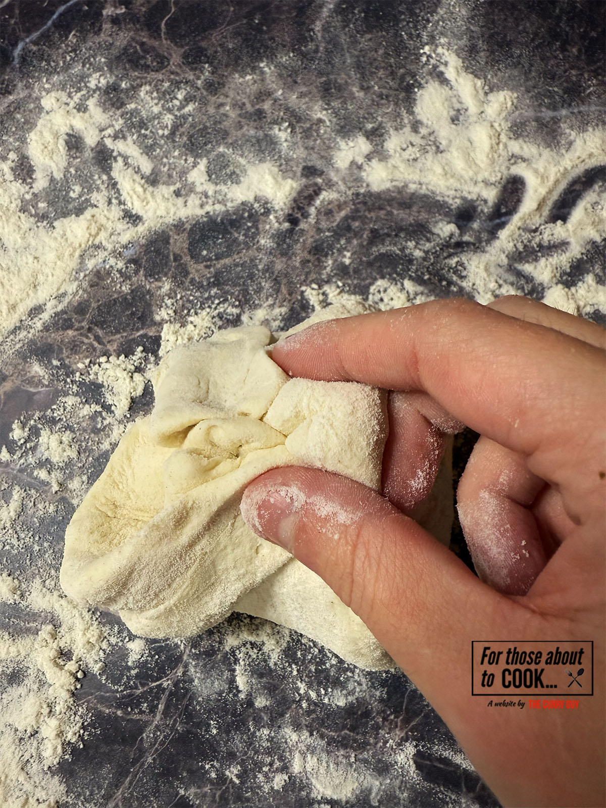 Pinching the naan dough together to seal