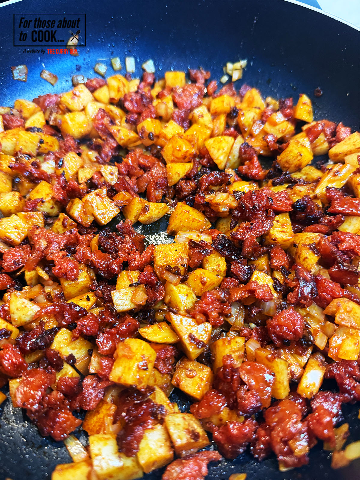stirring the chorizo into the potato for the taquitos
