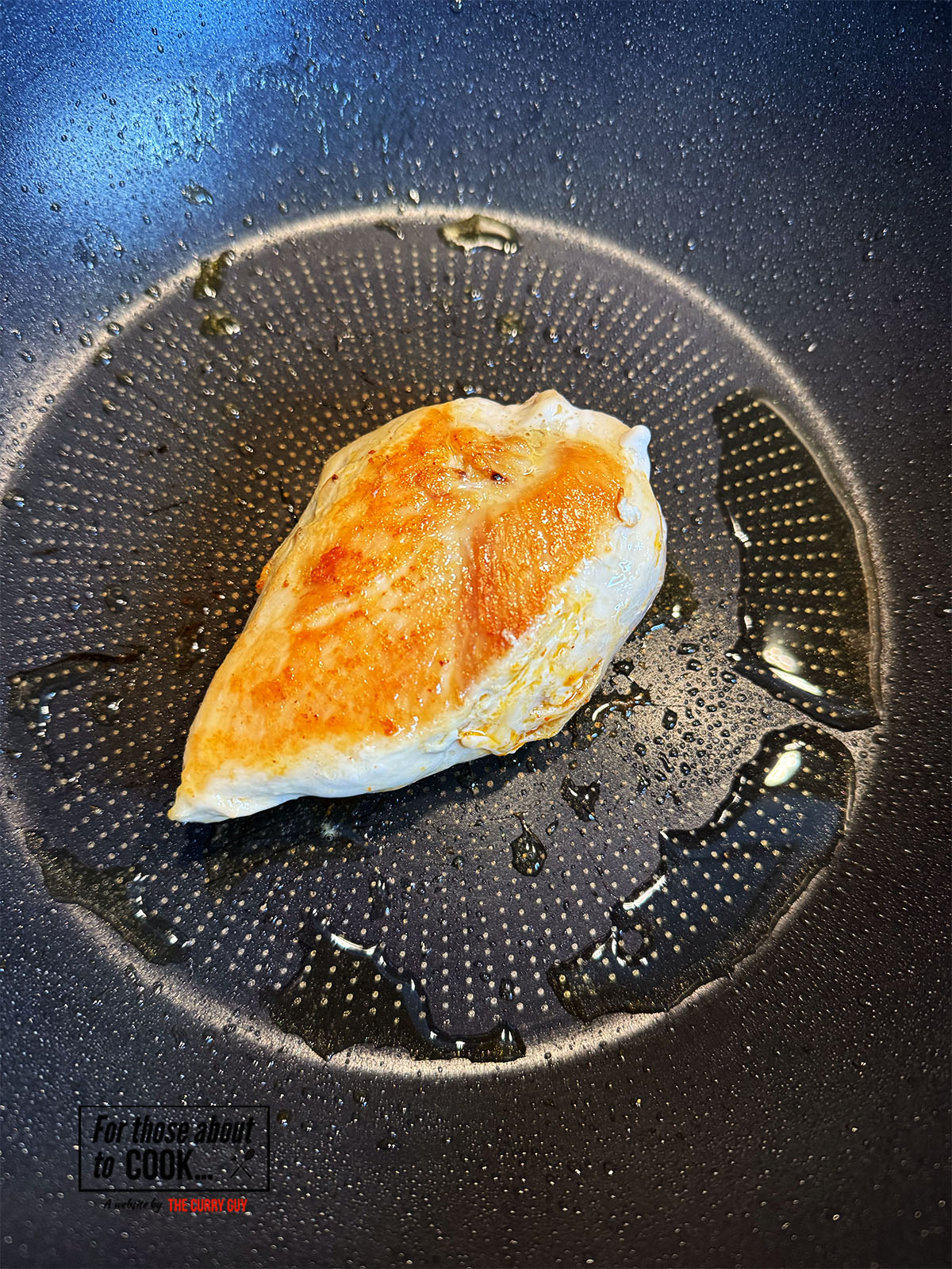 Chicken breast browning in a pan