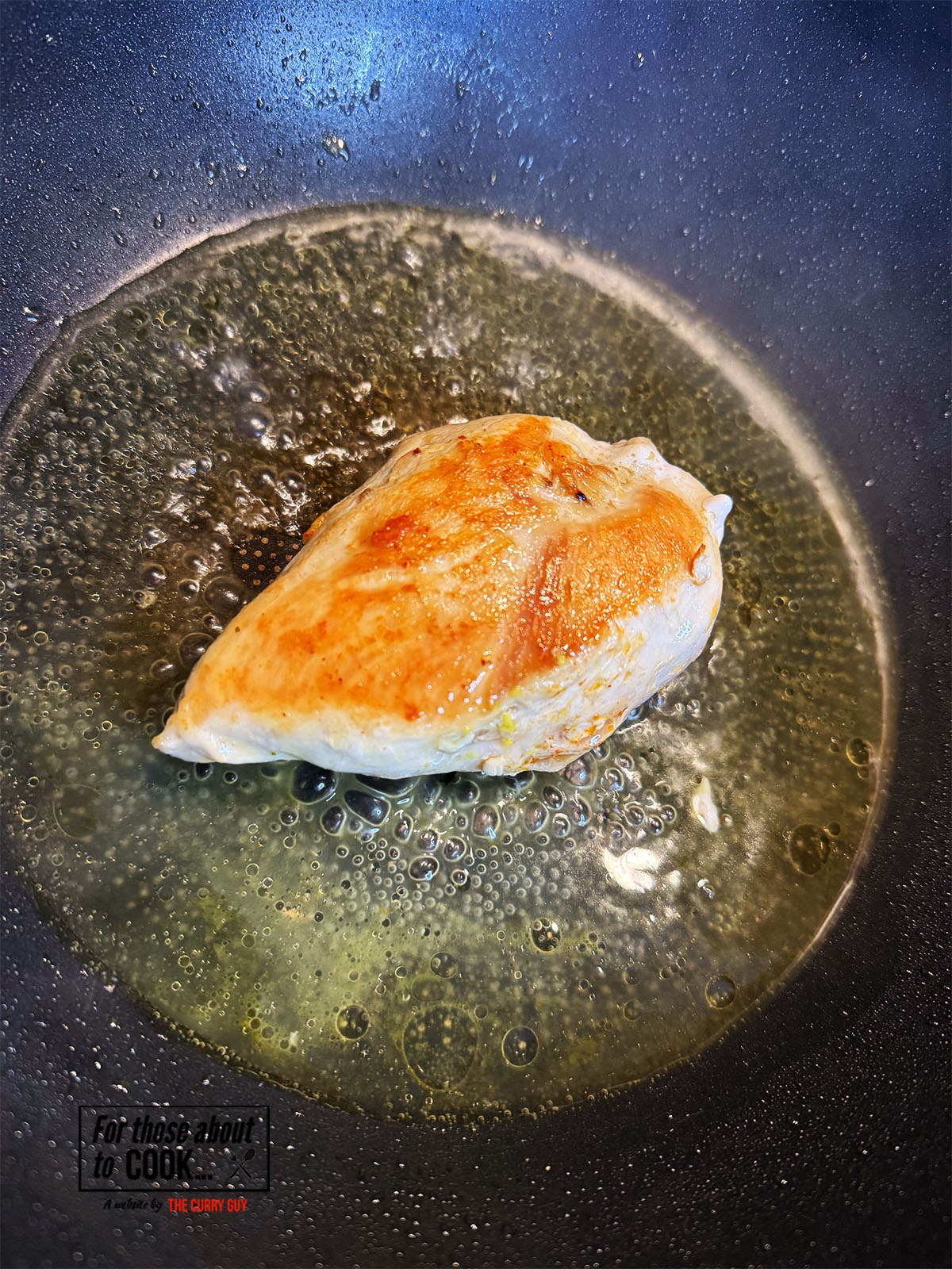 Chicken stock added to the pan with chicken breast