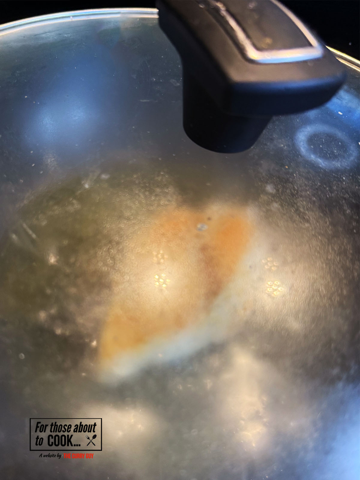 Lid placed over the chicken to poach