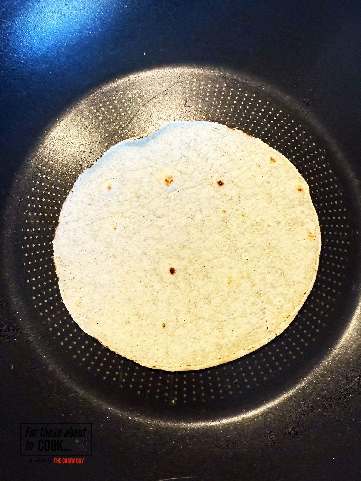 Corn tortillas dry frying in a pan